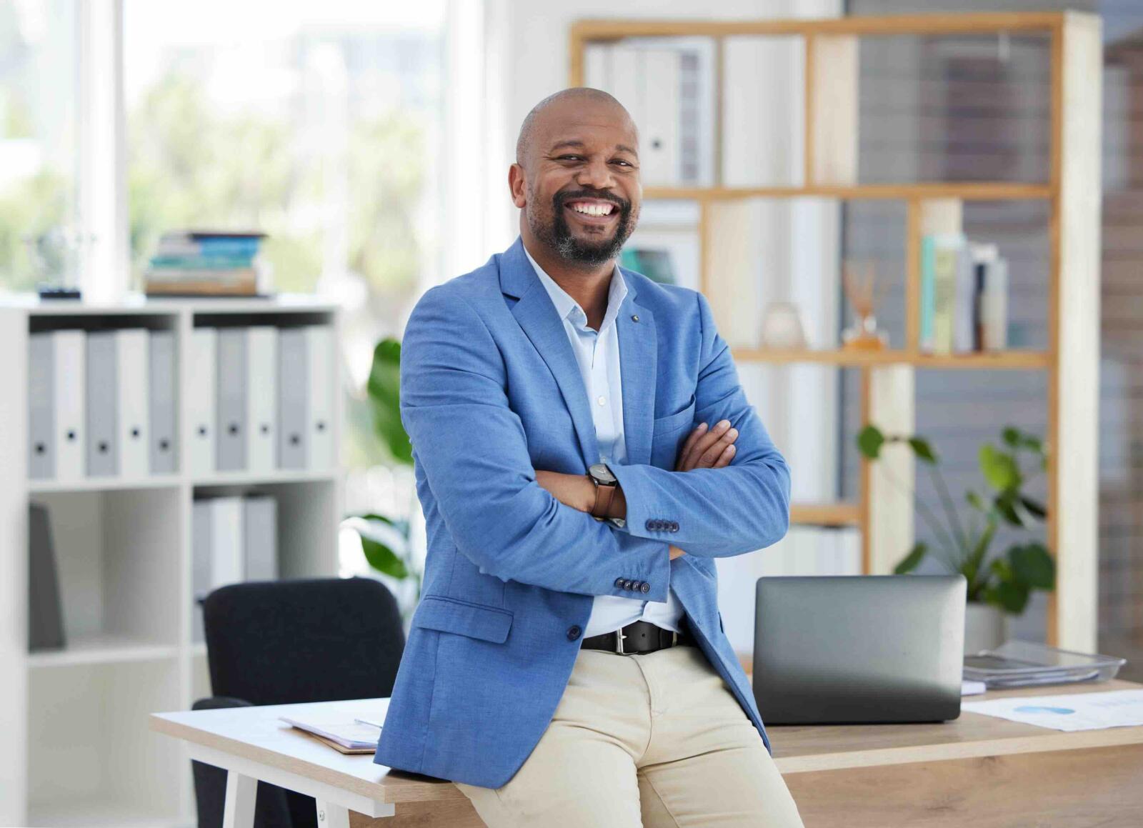success-corporate-leadership-portrait-black-man-sitting-desk-modern-office-startup-management-marketing-ceo-happy-male-entrepreneur-with-business-vision-creative-workplace